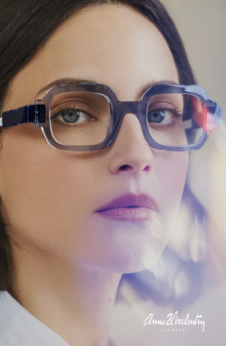 Woman wearing bold blue Anne et Valentin optical frames, a signature independent-eyewear look