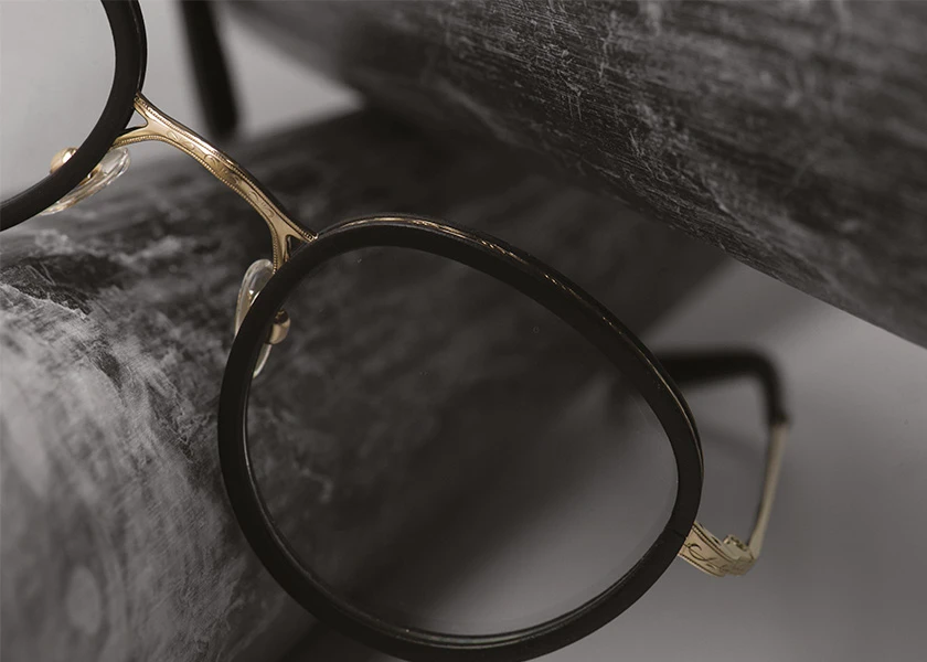 Gold and Wood eyewear frame in dark wood, close up, carried at City Optix in the Marina
