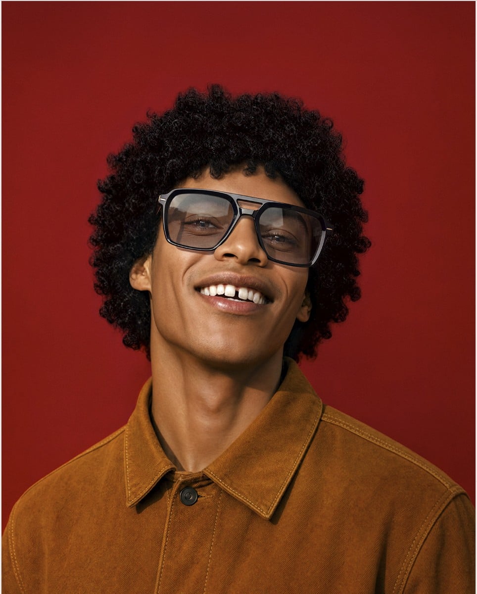 A man wearing dark Morel optical acetate frames, smiling.