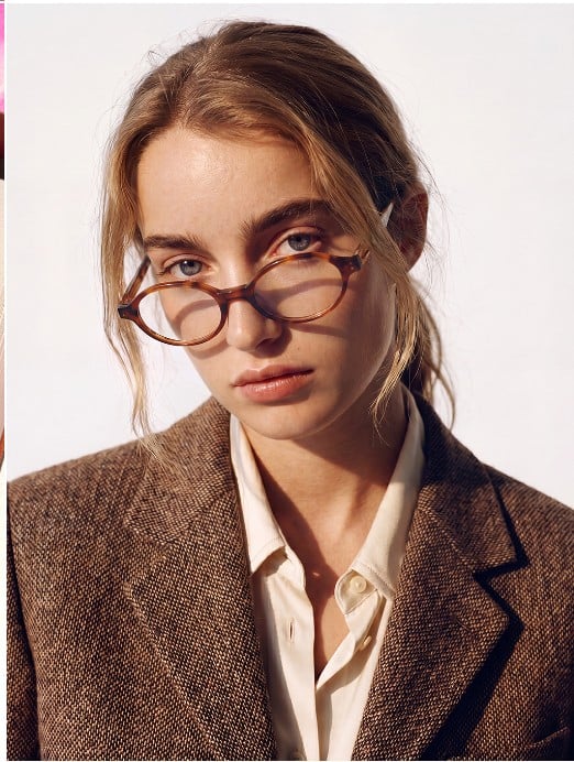 Close portrait of a woman wearing a round tortoiseshell Morel acetate frame.