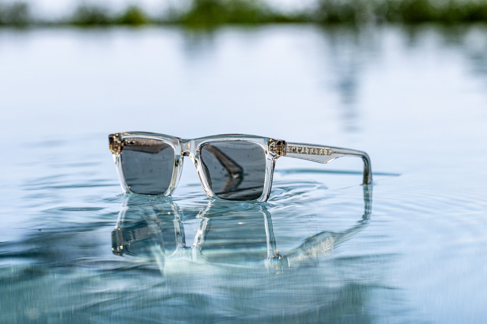 Torus crystal acetate frame resting on water surface
